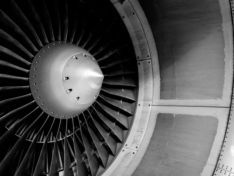 Blades of an aircraft engine close-up. Travel and aerospace concept. Black and white filter