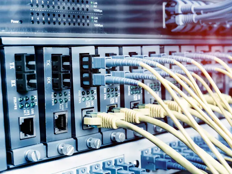 Fiber Optic cables connected to optic ports and UTP and Network cables connected to ethernet ports