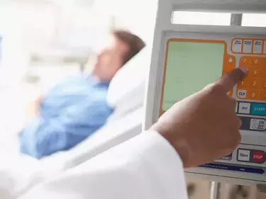 Healthcare worker monitoring patient