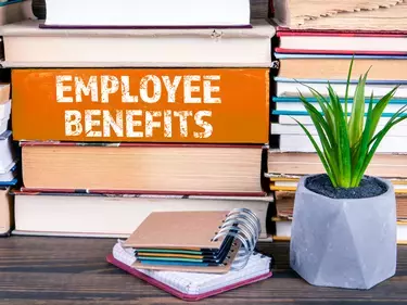 Employee Benefits on Stack of Books