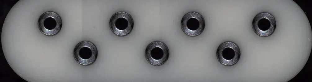 Selectively machined titanium plated ceramic plate